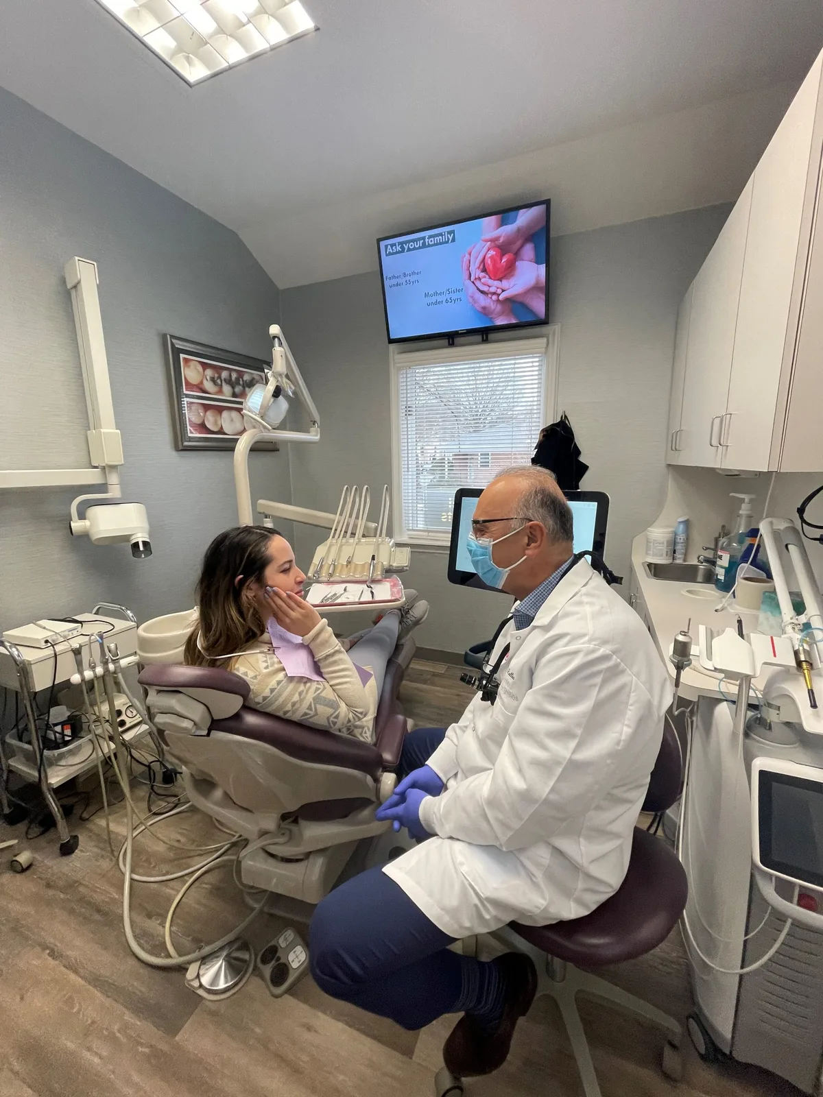 Dr. Nicholas Rallis consulting with a patient at Center for Smiles
