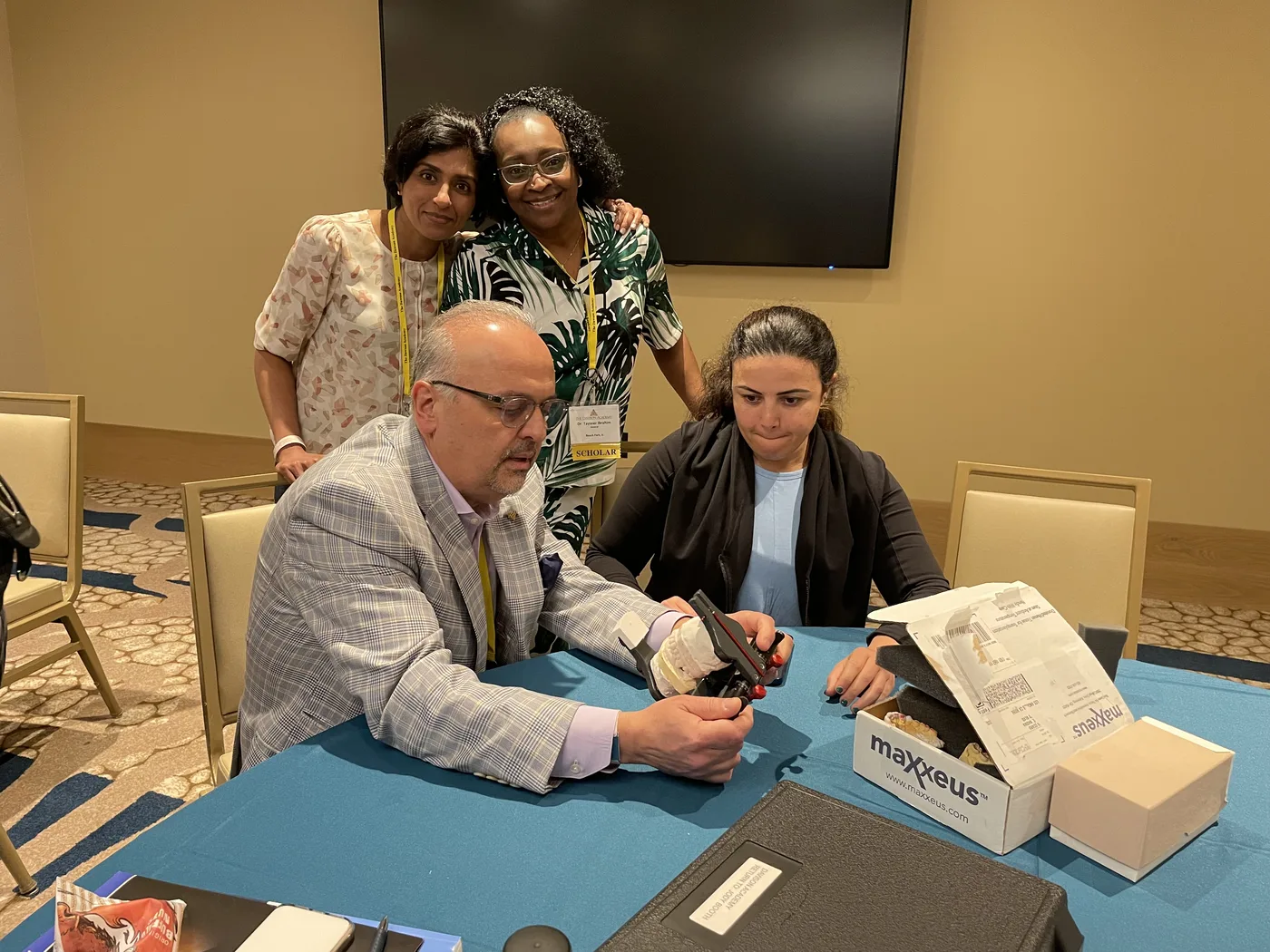 Dr. Nicholas Rallis sharing dental knowledge with colleagues at an educational event